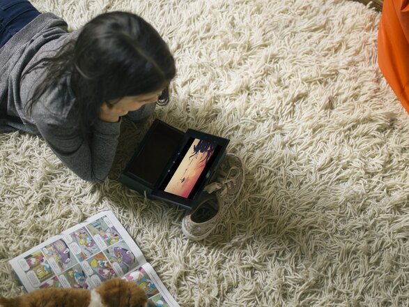 Media Narrative - Girl laying on carpet watching film on tablet_original.tif