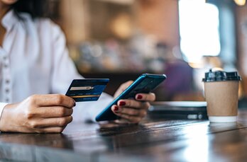 pay-for-goods-by-credit-card-through-a-smartphone-in-a-coffee-shop