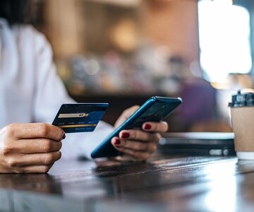 pay-for-goods-by-credit-card-through-a-smartphone-in-a-coffee-shop